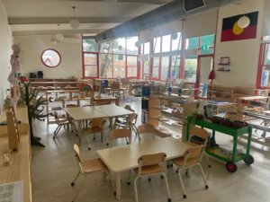 Childcare centre classroom learning environment with tables, chairs, educational toys and indoor activity areas